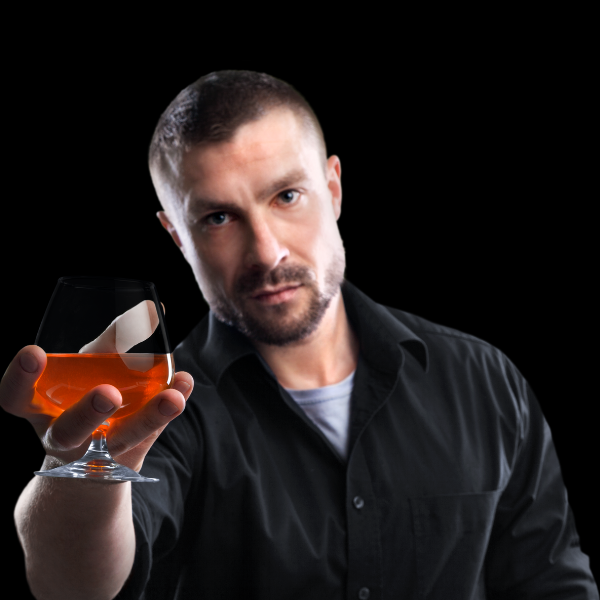 Barman serwujący lampkę brendy.